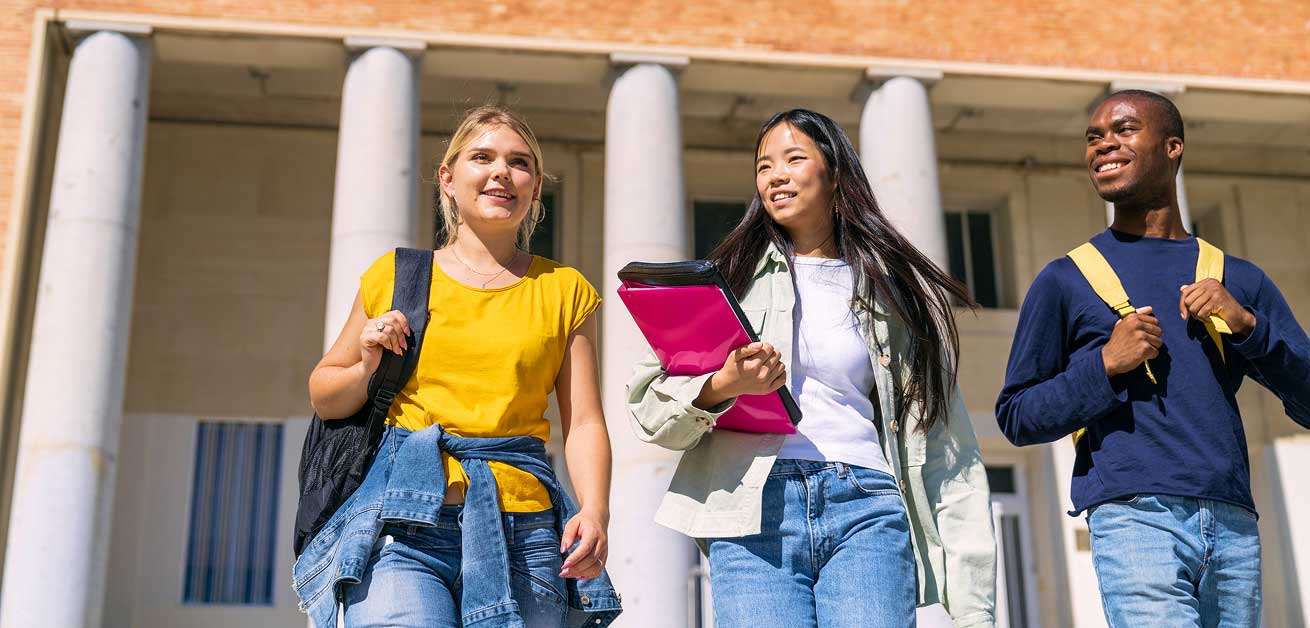 smiling students walking on campus
